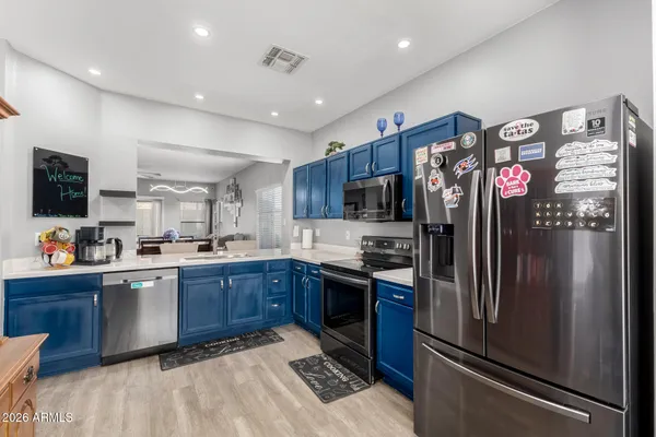 a kitchen with stainless steel appliances granite countertop a refrigerator and a sink