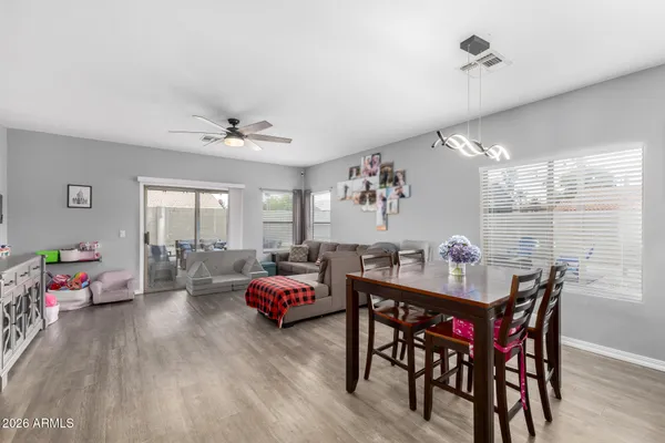 a living room with furniture kitchen view and a window