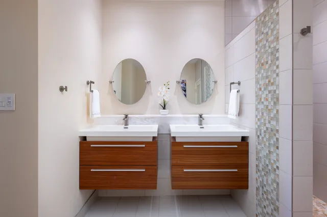 a bathroom with a double vanity sink and a mirror