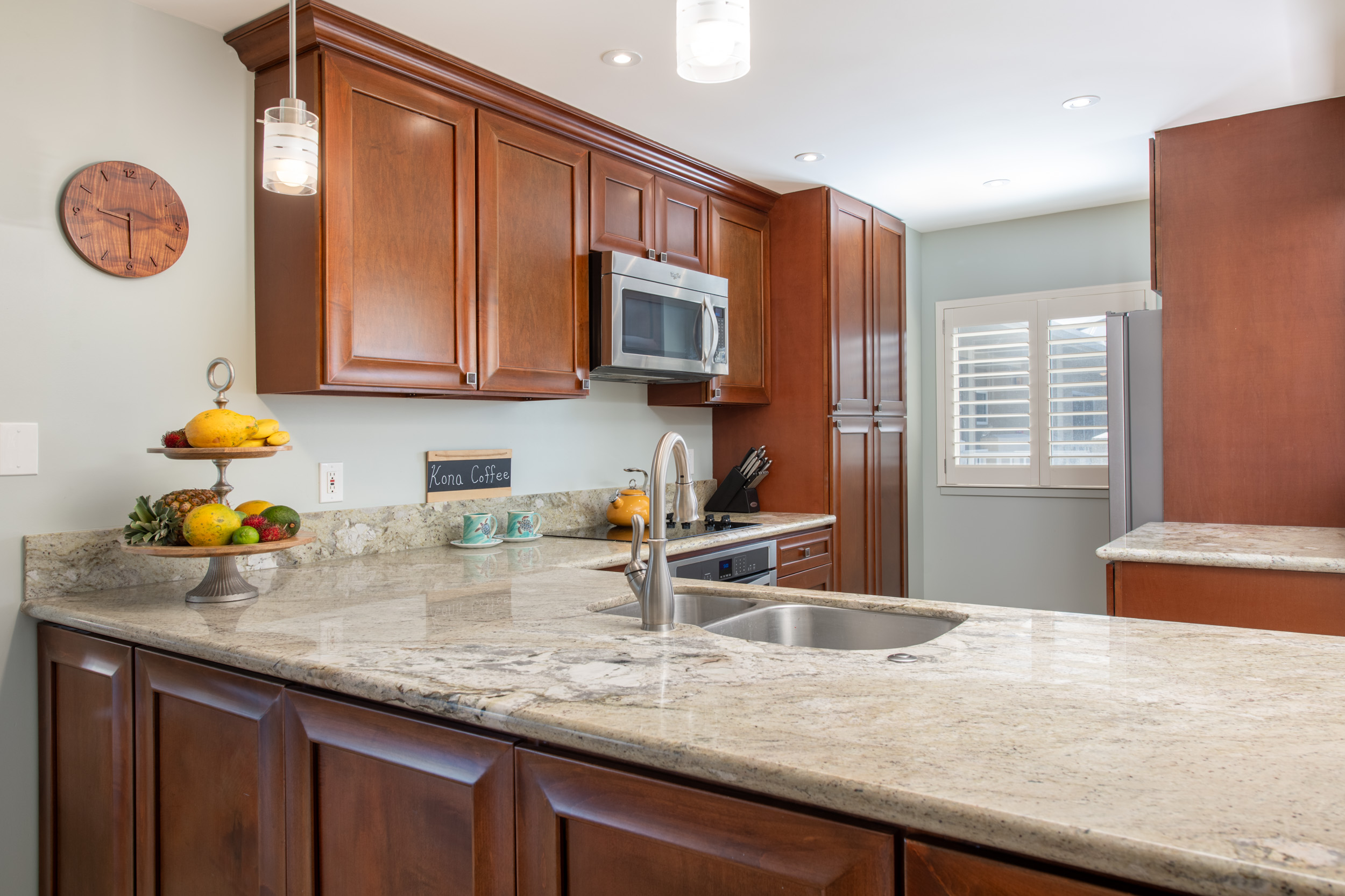 69-1010 Keana Place, Unit G303 Waikoloa, HI 96738 - Photo 8 of 30 a kitchen with sink cabinets and appliances