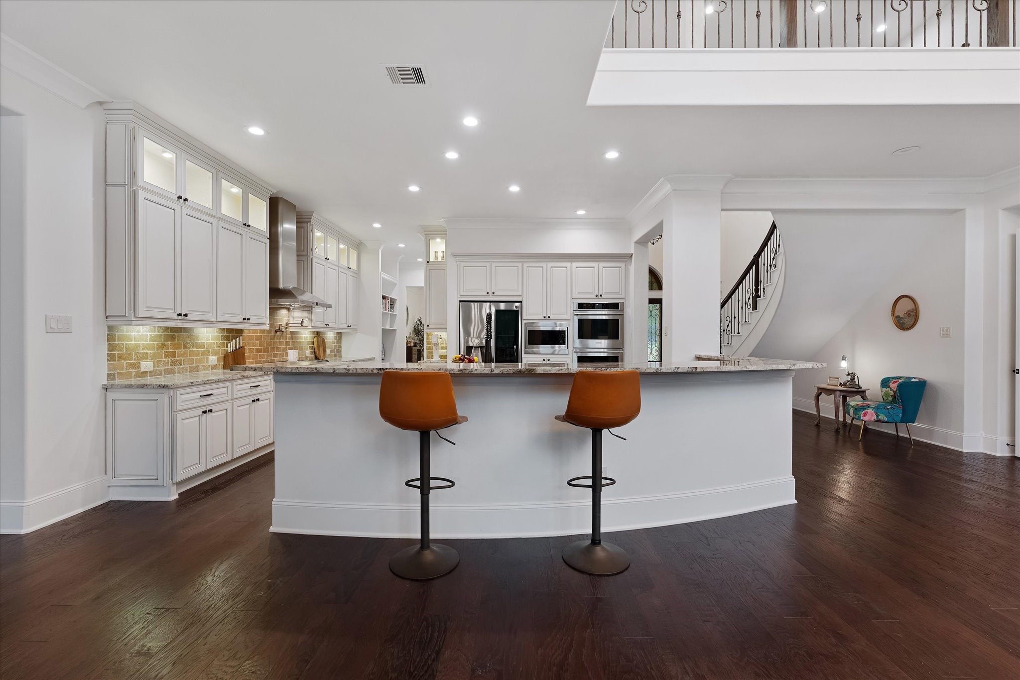 28733 Lakeside Green Magnolia, TX 77355 - Photo 27 of 49 a kitchen with stainless steel appliances kitchen island granite countertop a stove a sink a refrigerator and white cabinets with wooden floor