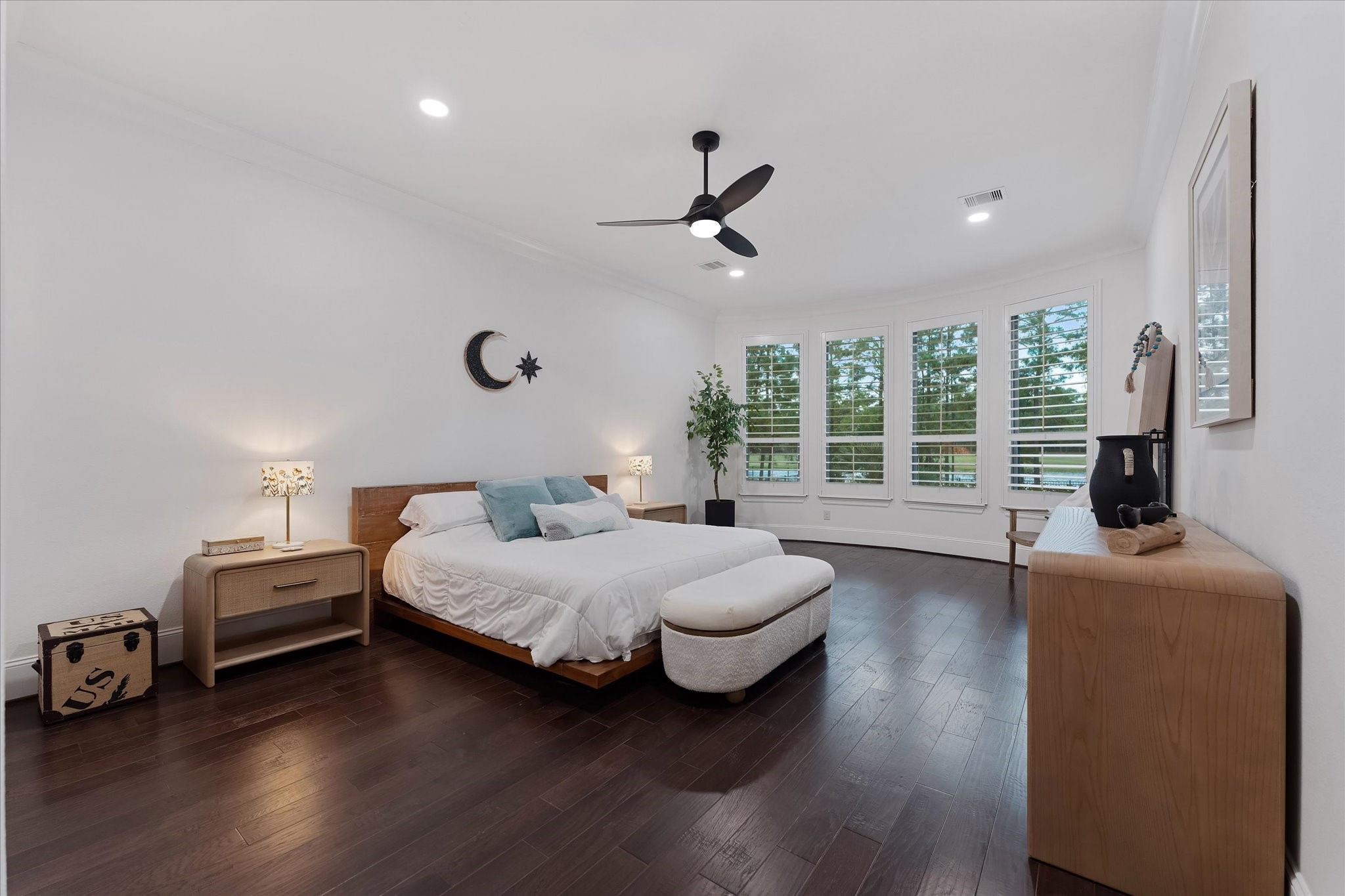 28733 Lakeside Green Magnolia, TX 77355 - Photo 36 of 49 a spacious bedroom with a bed and wooden floor