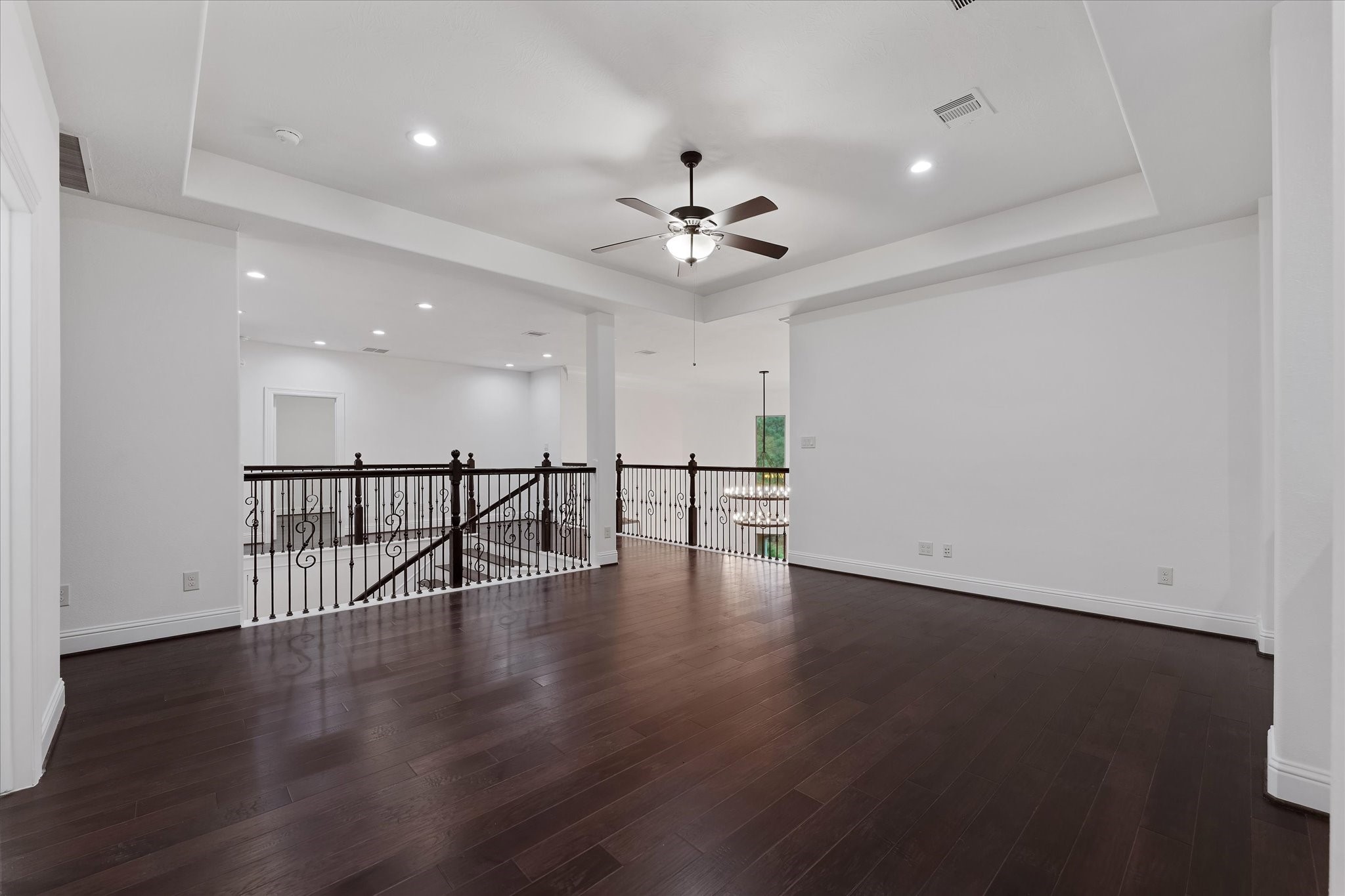 28733 Lakeside Green Magnolia, TX 77355 - Photo 41 of 49 a view of an empty room with wooden floor and a ceiling fan