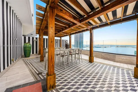 a view of a patio with couches table and chairs and potted plants