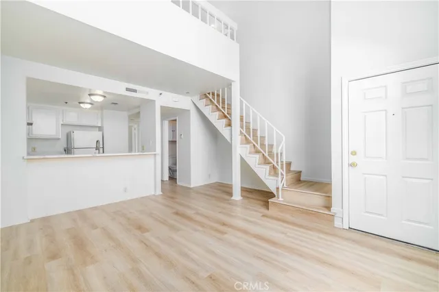 a view of staircase and kitchen with wooden floor