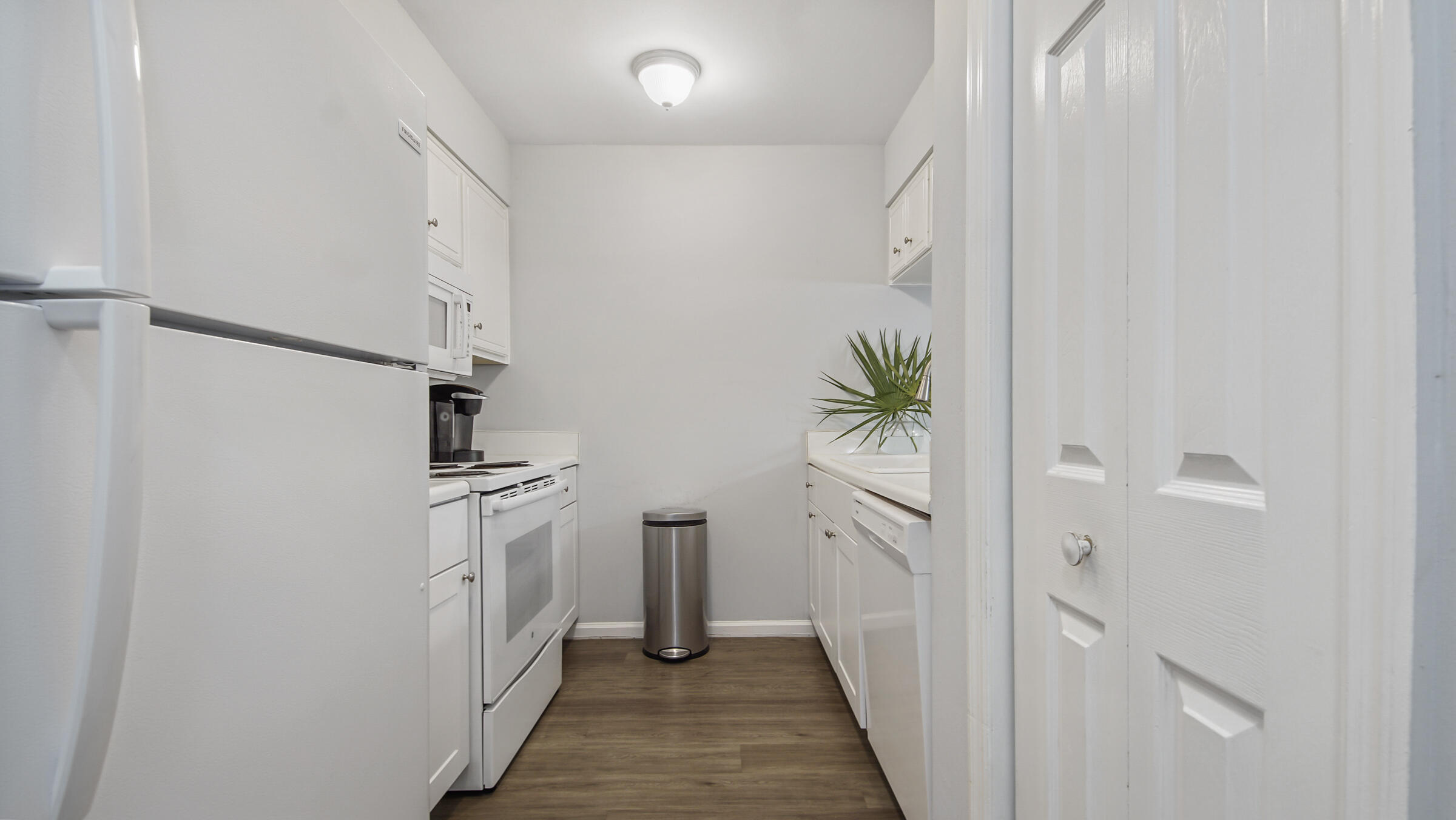 51 Cypress Street, Unit 275 Santa Rosa Beach, FL 32459 - Photo 11 of 37 a hallway with white cabinets and wooden floor