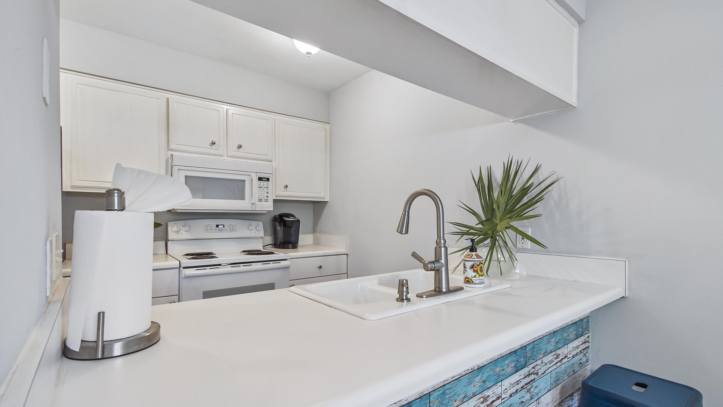 51 Cypress Street, Unit 275 Santa Rosa Beach, FL 32459 - Photo 6 of 37 a kitchen with stainless steel appliances a sink a stove and white cabinets