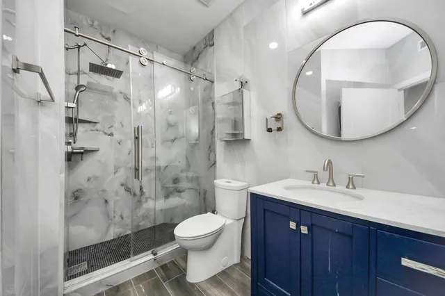 a bathroom with a sink a toilet and a mirror