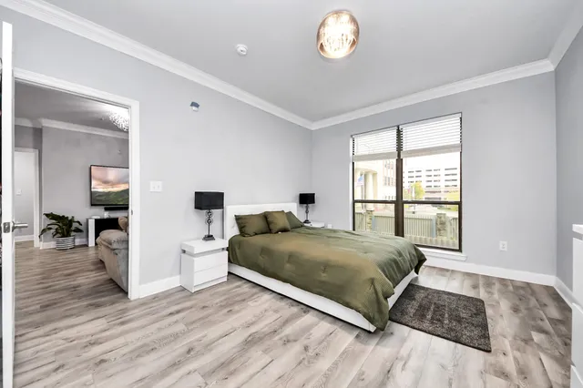 a living room with a bed furniture and a large window