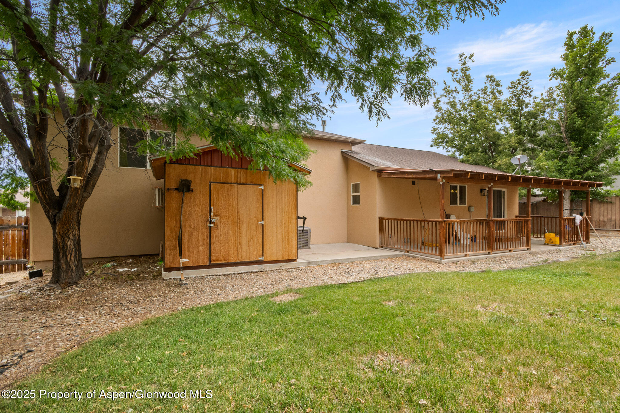 1760 Anvil View Avenue Rifle, CO 81650 - Photo 18 of 22 a view of a backyard with a house and large tree