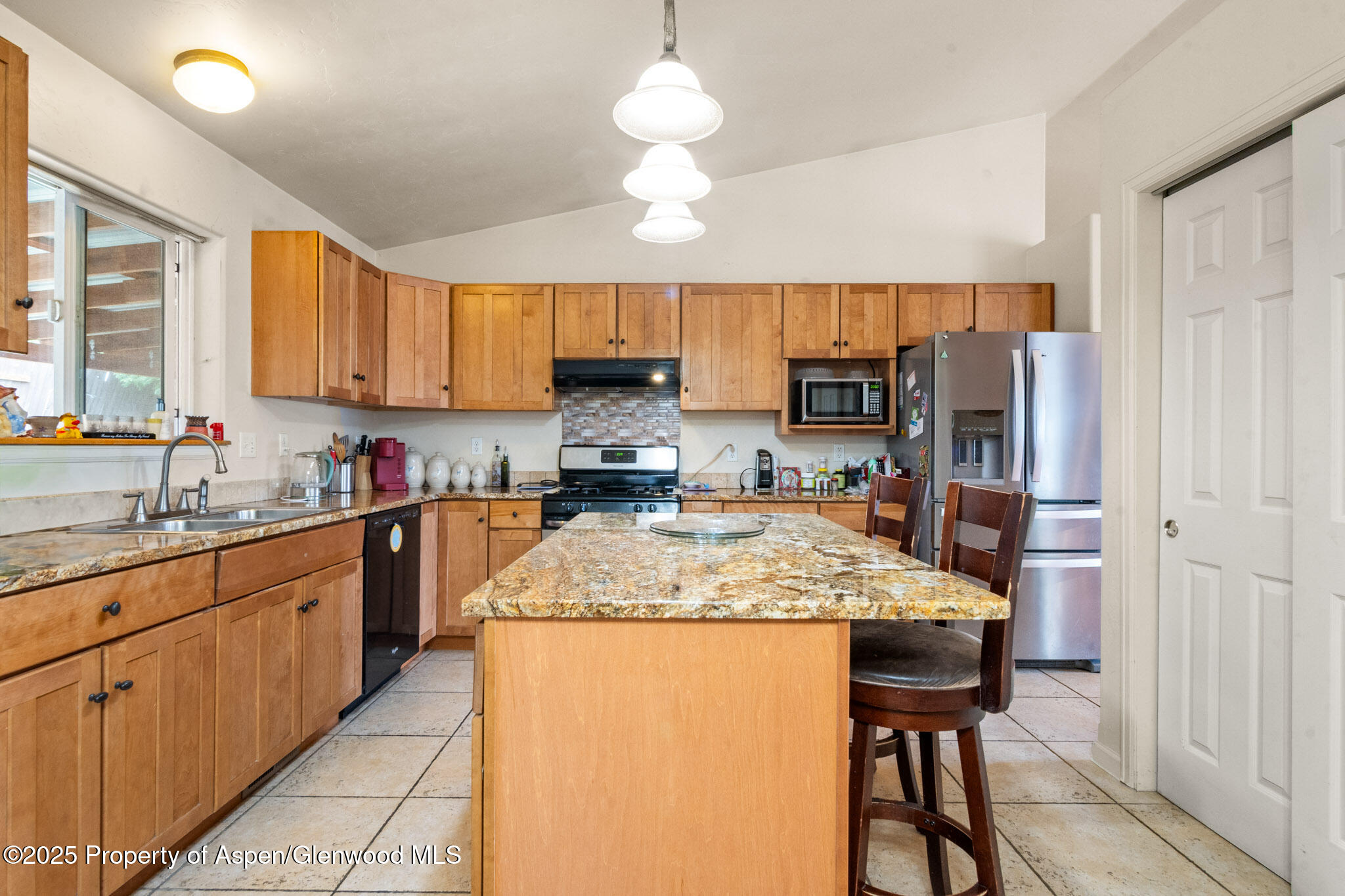 1760 Anvil View Avenue Rifle, CO 81650 - Photo 8 of 22 a kitchen with stainless steel appliances granite countertop a sink refrigerator and cabinets