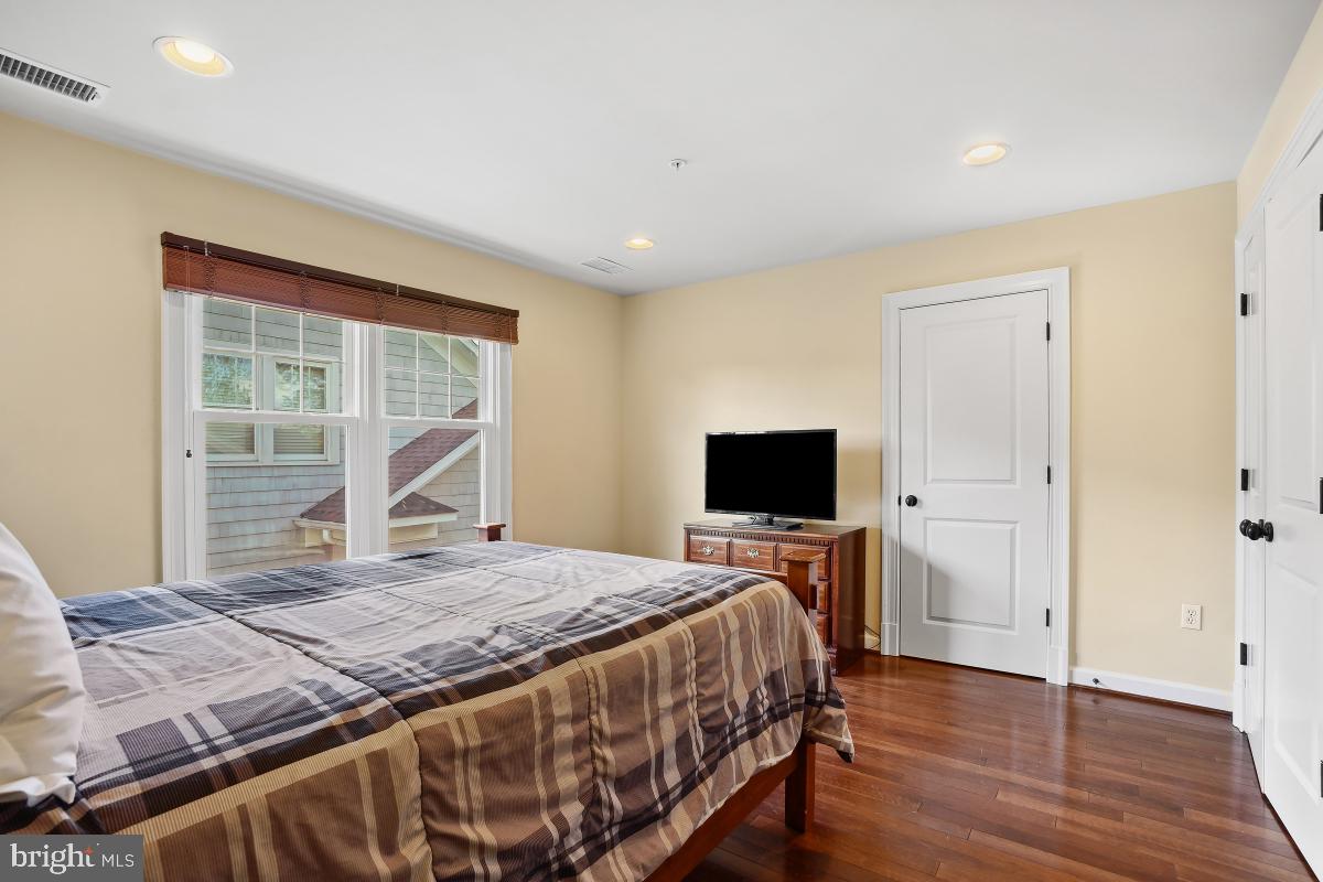 7106 Exeter Road Bethesda, MD 20814 - Photo 25 of 41 a bedroom with a bed and a flat screen tv