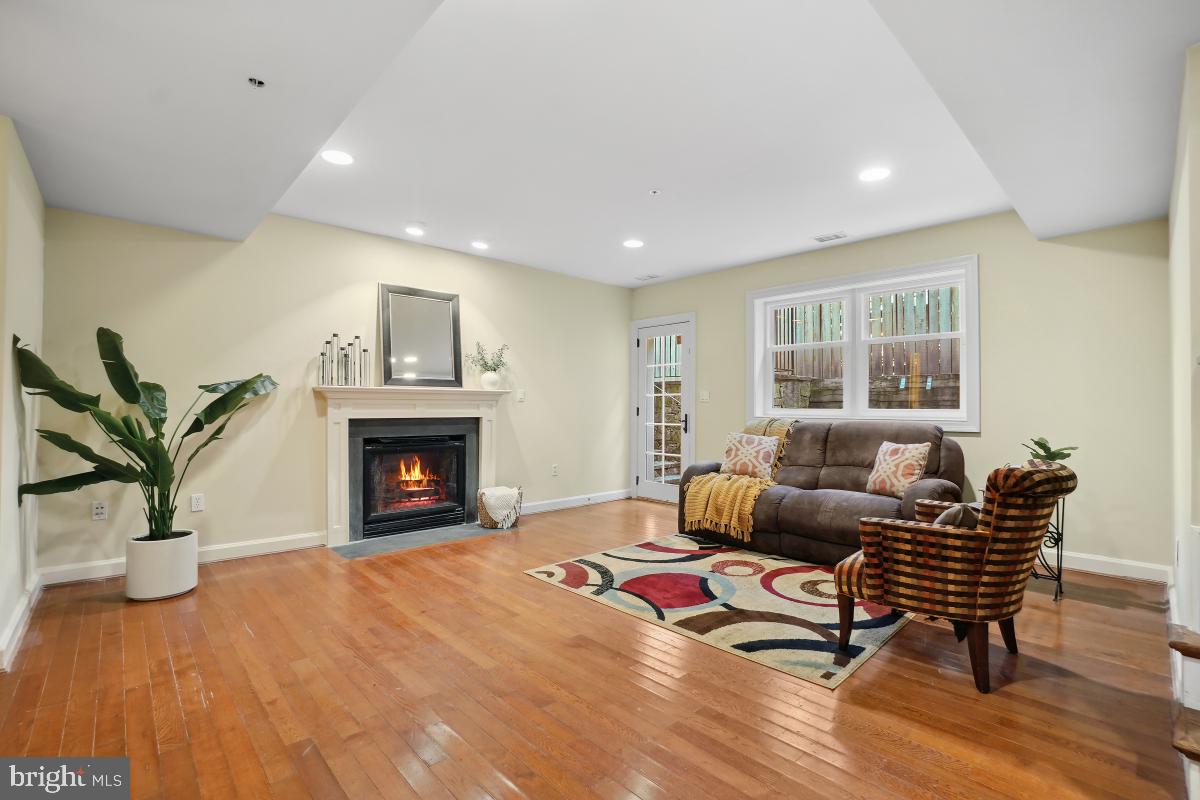 7106 Exeter Road Bethesda, MD 20814 - Photo 27 of 41 a living room with furniture a fireplace and a potted plant