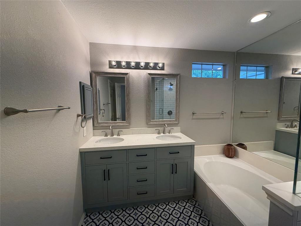 3109 Bonsai Drive Plano, TX 75093 - Photo 15 of 25 a bathroom with a sink a toilet and a mirror