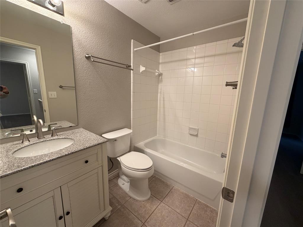 3109 Bonsai Drive Plano, TX 75093 - Photo 18 of 25 a bathroom with a granite countertop sink toilet and shower