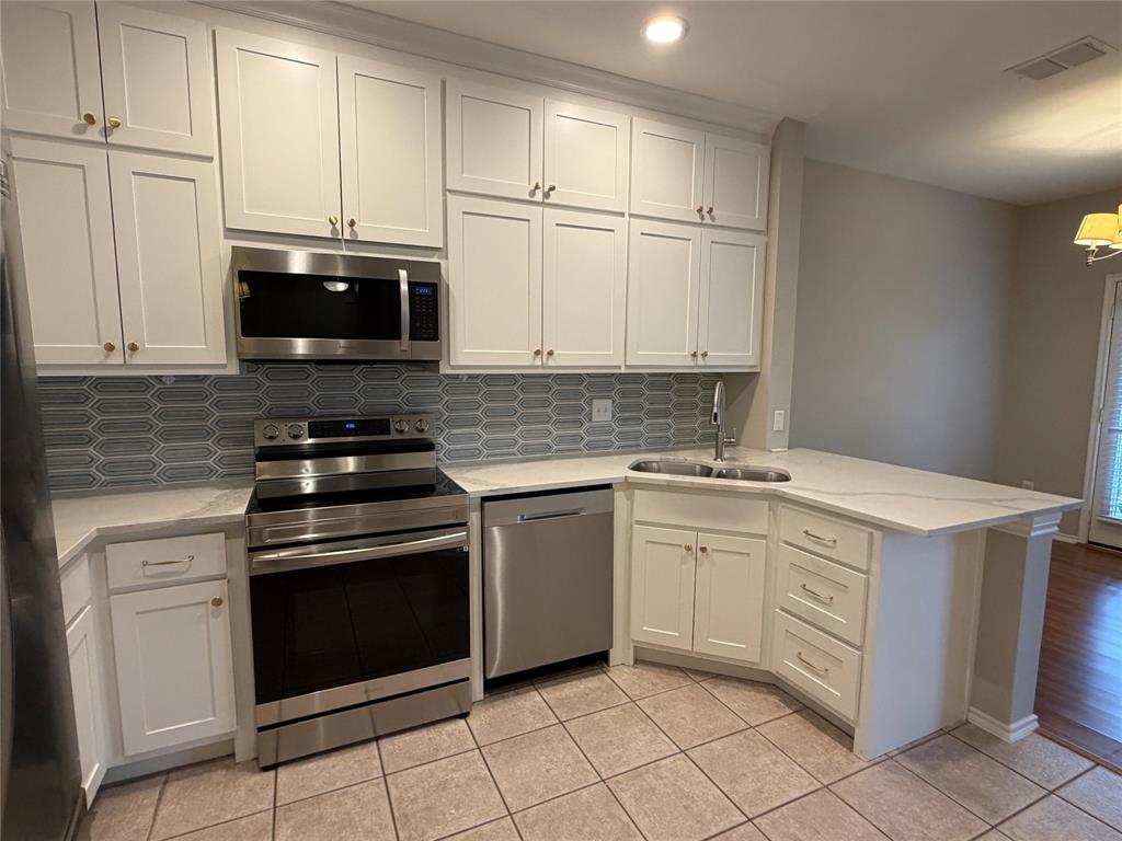 3109 Bonsai Drive Plano, TX 75093 - Photo 5 of 25 a kitchen with cabinets stainless steel appliances and a sink