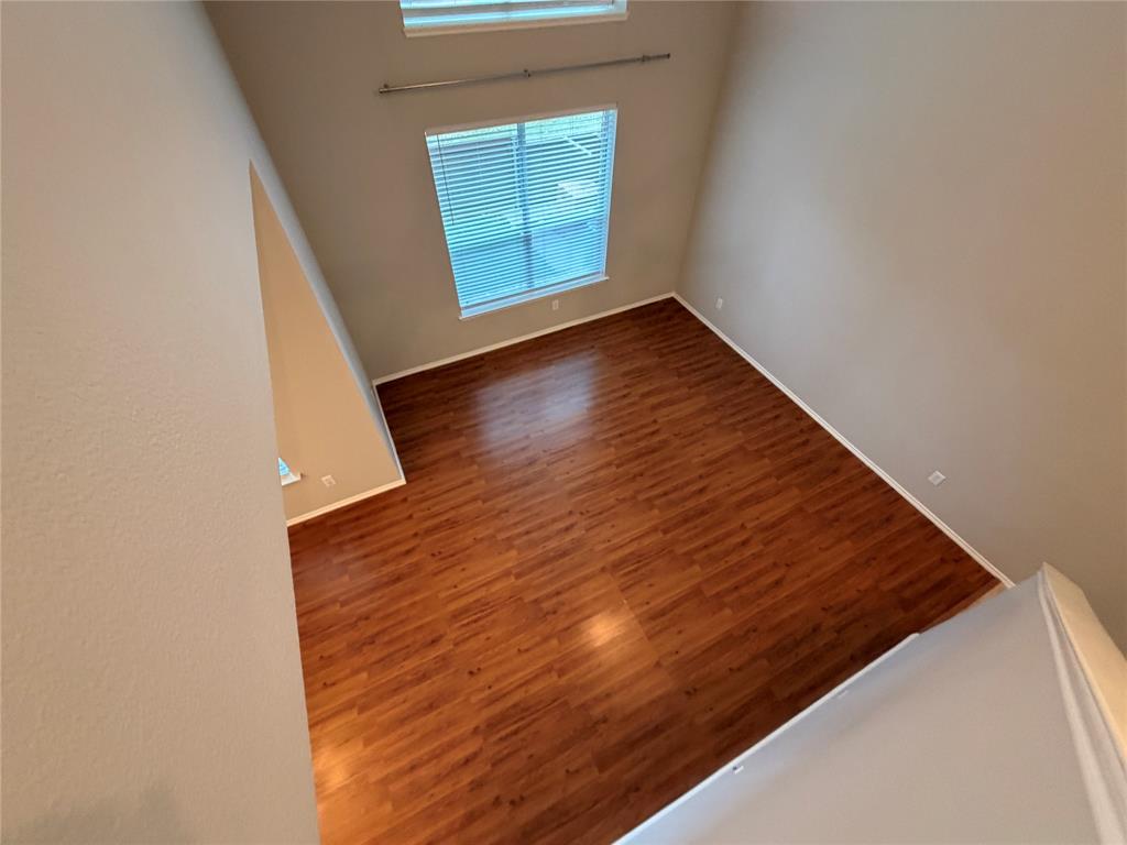3109 Bonsai Drive Plano, TX 75093 - Photo 10 of 25 a view of an empty room with wooden floor and a window