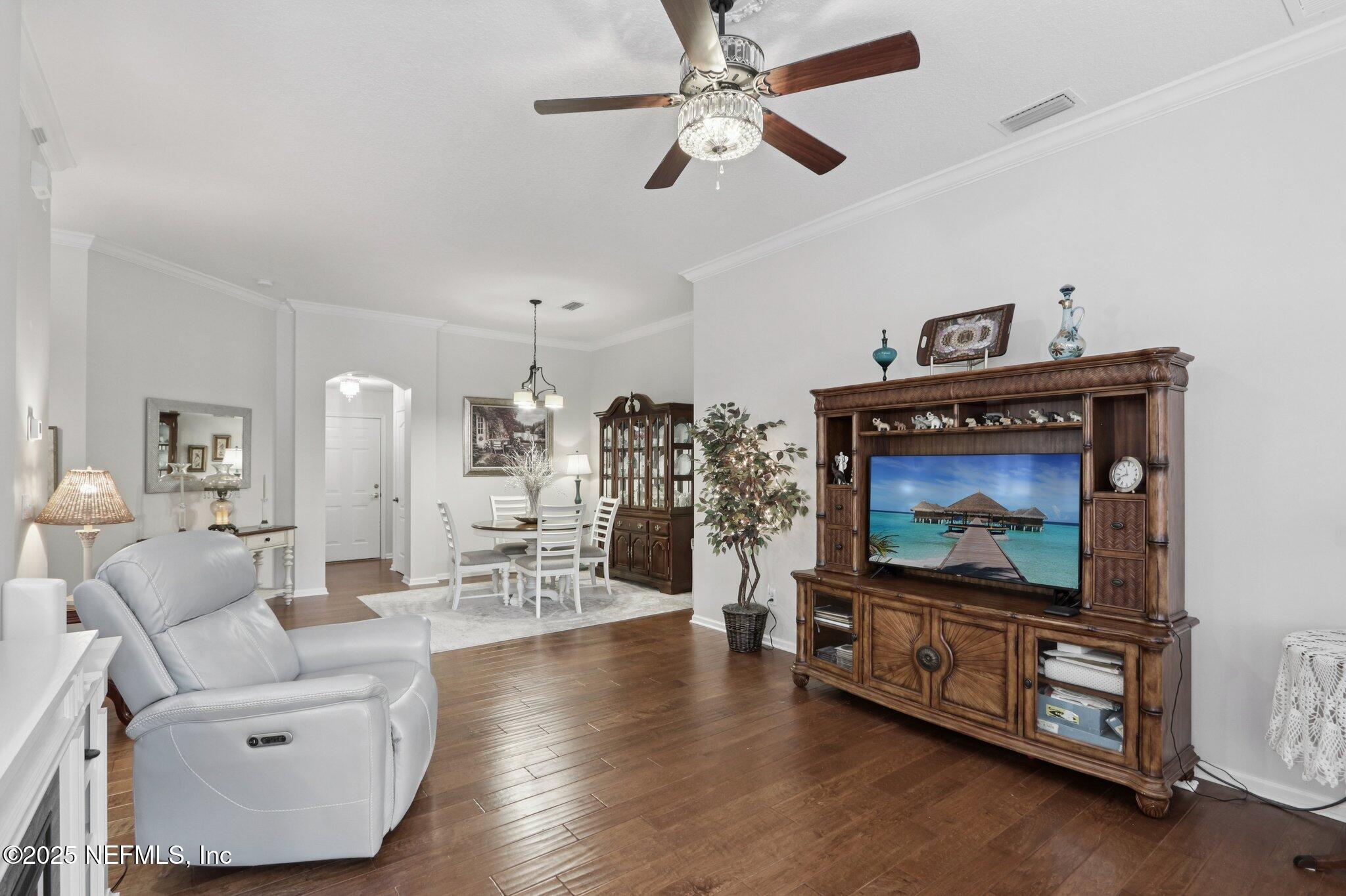 1870 Copper Stone Drive, Unit F Fleming Island, FL 32003 - Photo 11 of 36 a living room with furniture and a flat screen tv