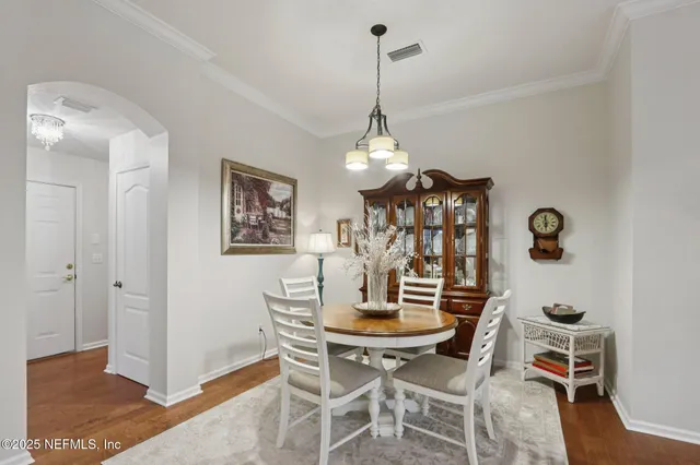 a view of a dining room with furniture and chandelier