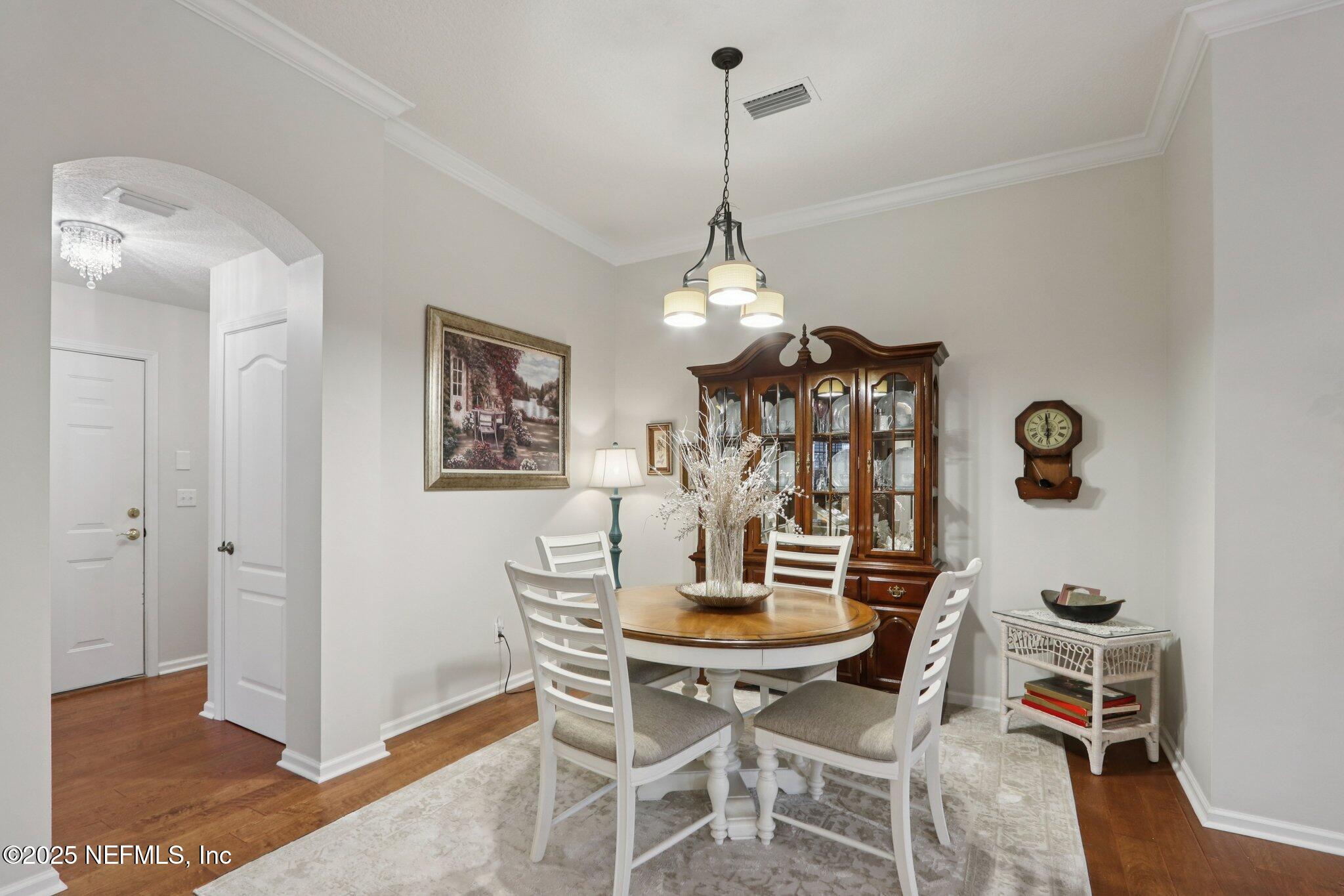 1870 Copper Stone Drive, Unit F Fleming Island, FL 32003 - Photo 12 of 36 a view of a dining room with furniture and chandelier