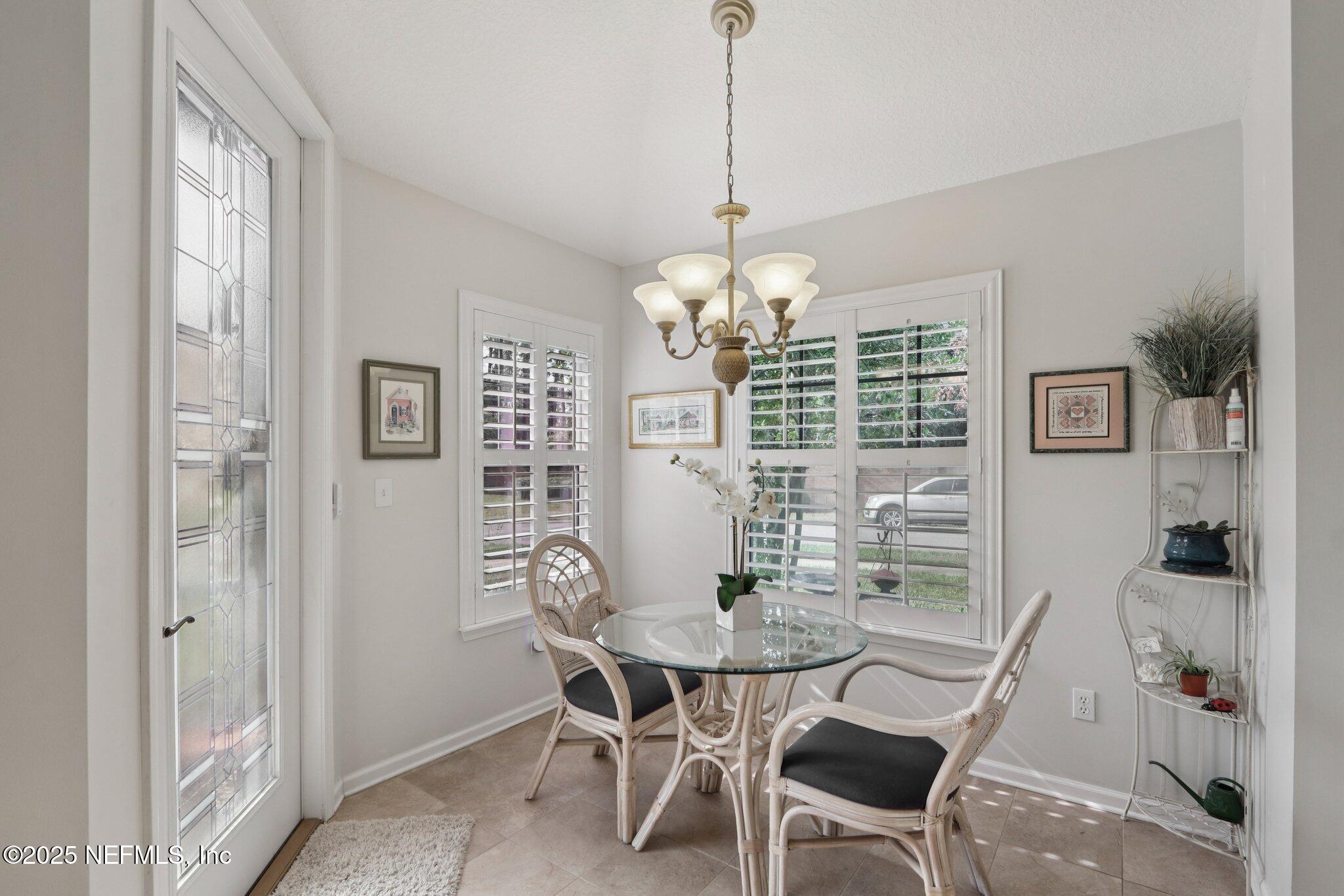1870 Copper Stone Drive, Unit F Fleming Island, FL 32003 - Photo 15 of 36 a view of a dining room with furniture window and wooden floor