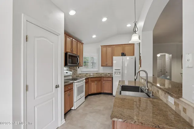 a large kitchen with cabinets and stainless steel appliances