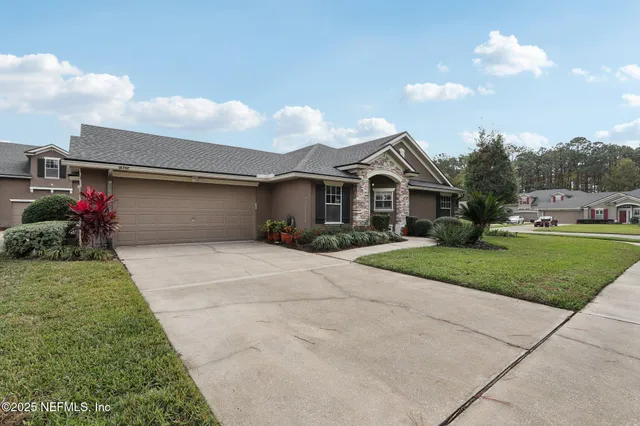 a front view of a house with a yard and a garage