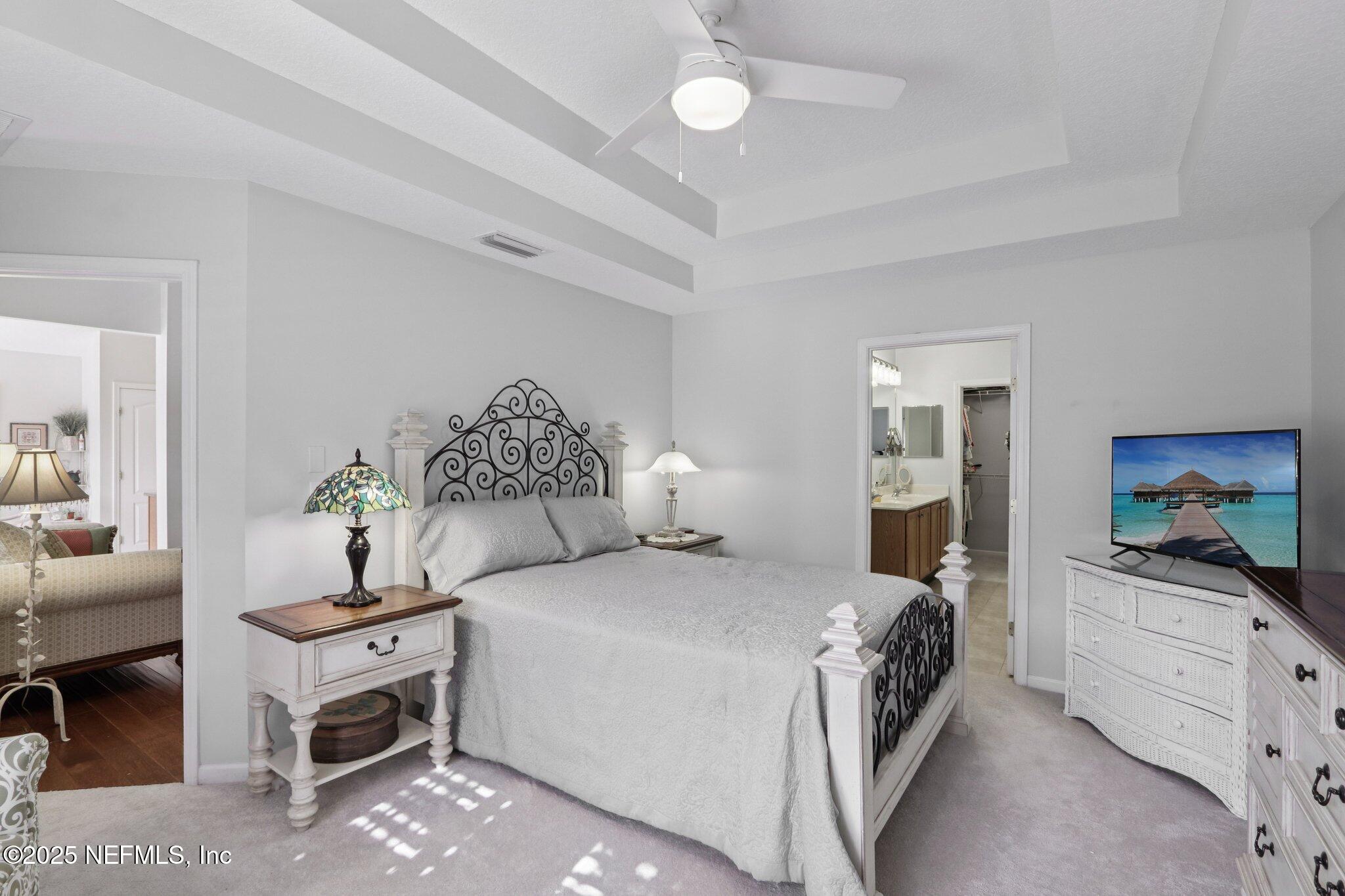 1870 Copper Stone Drive, Unit F Fleming Island, FL 32003 - Photo 27 of 36 a bedroom with a bed and wooden floor