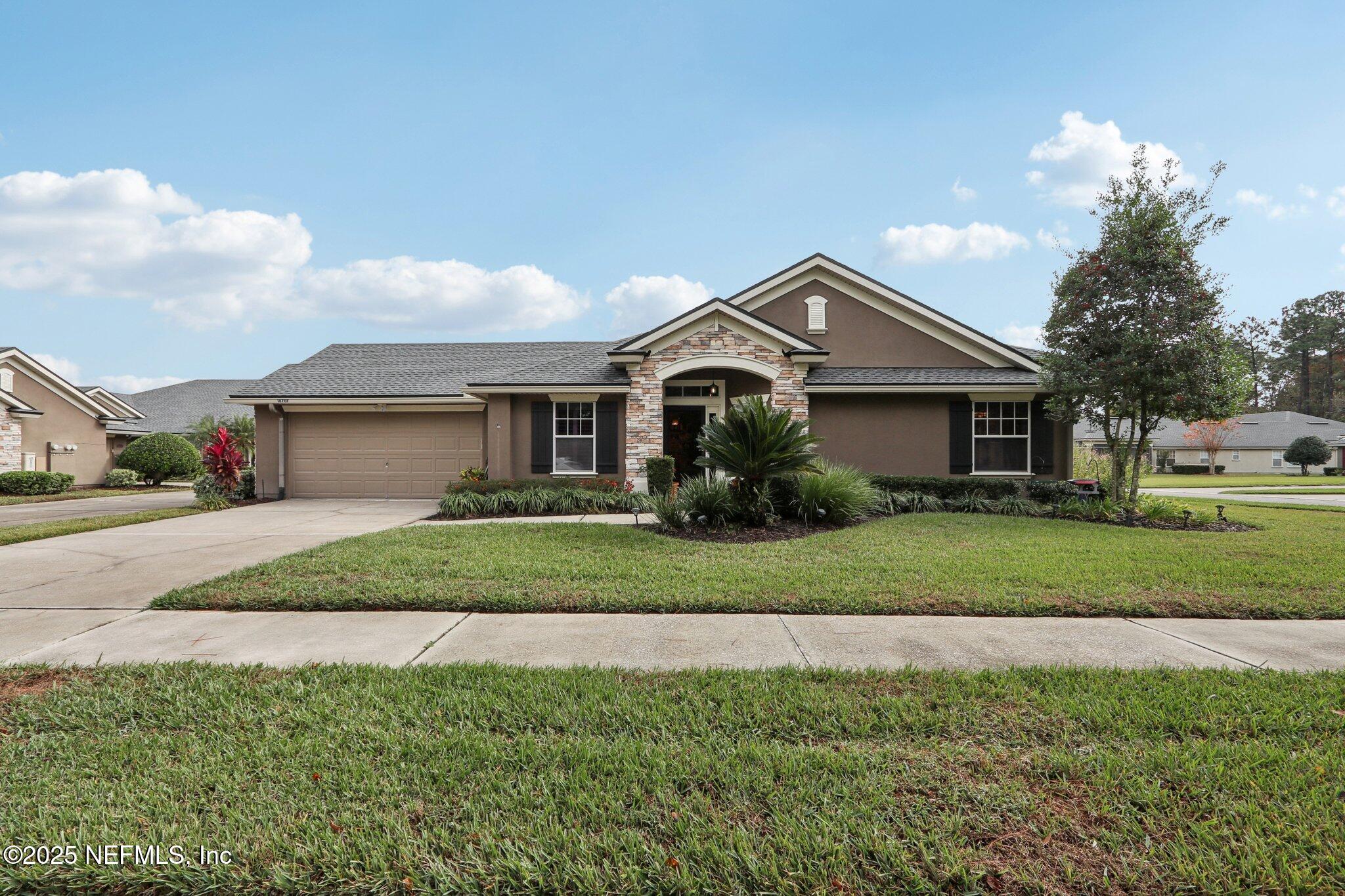 1870 Copper Stone Drive, Unit F Fleming Island, FL 32003 - Photo 3 of 36 a front view of a house with a yard