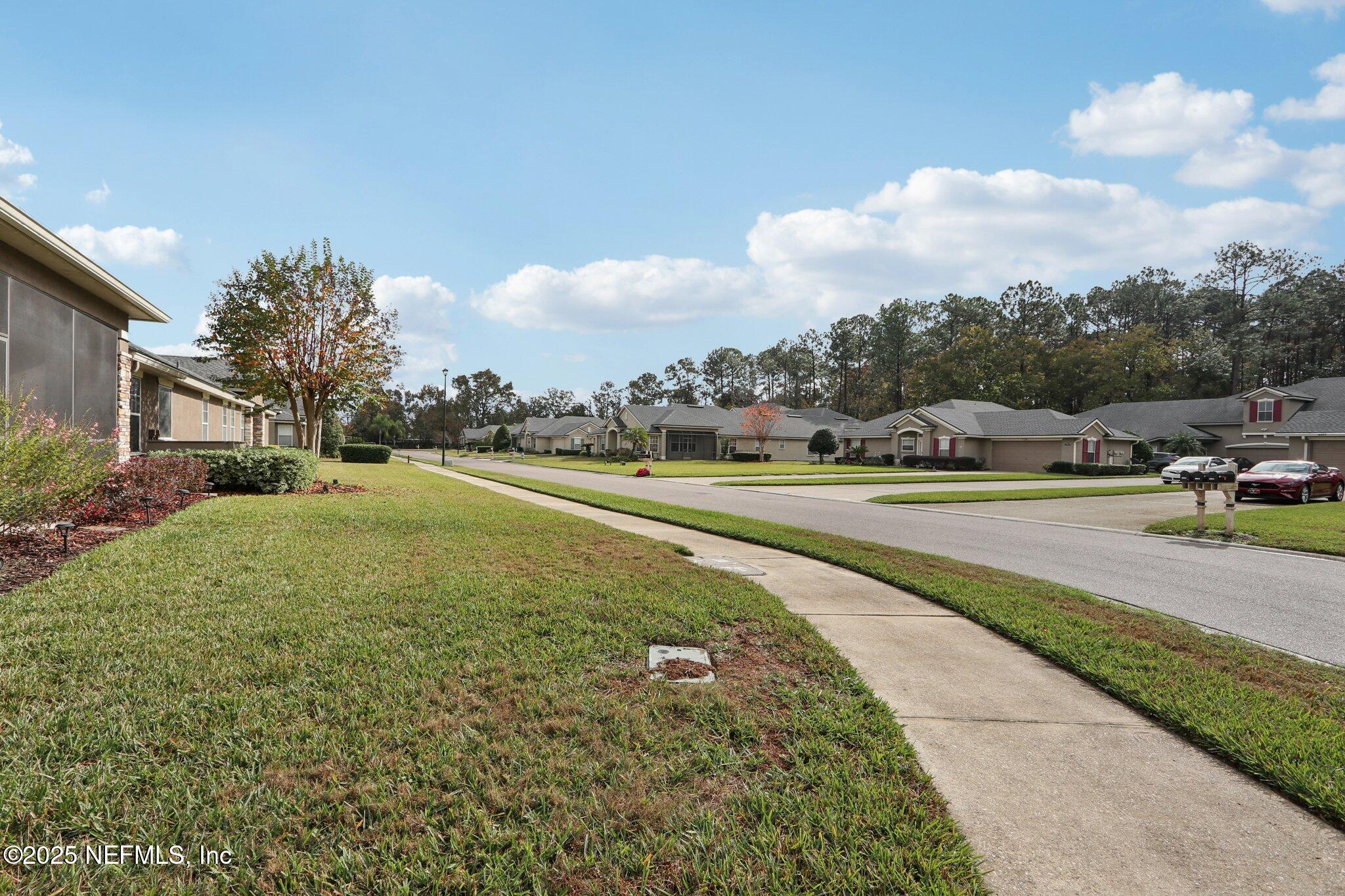 1870 Copper Stone Drive, Unit F Fleming Island, FL 32003 - Photo 34 of 36 a view of a street with houses