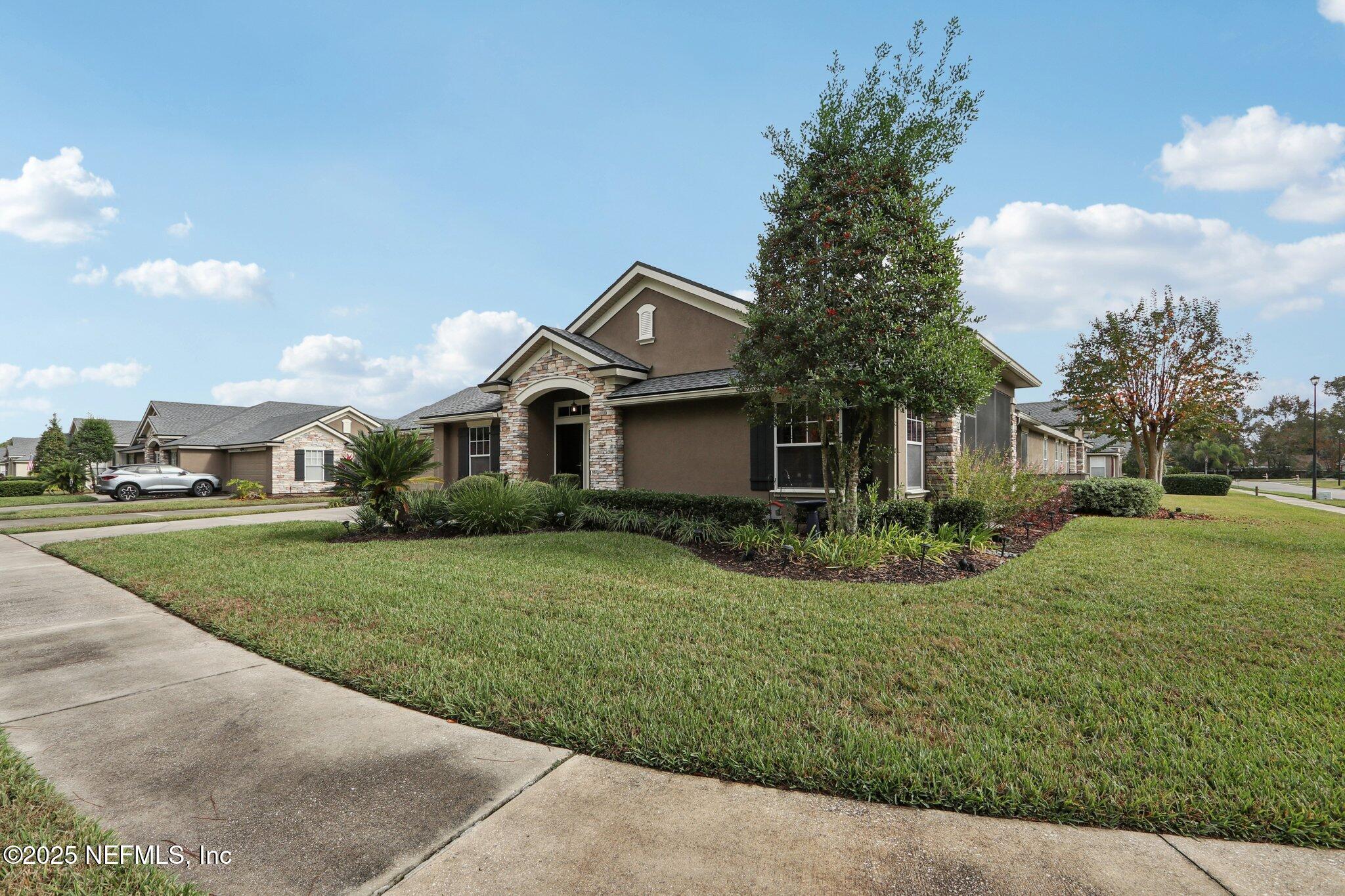 1870 Copper Stone Drive, Unit F Fleming Island, FL 32003 - Photo 4 of 36 a front view of a house with a yard