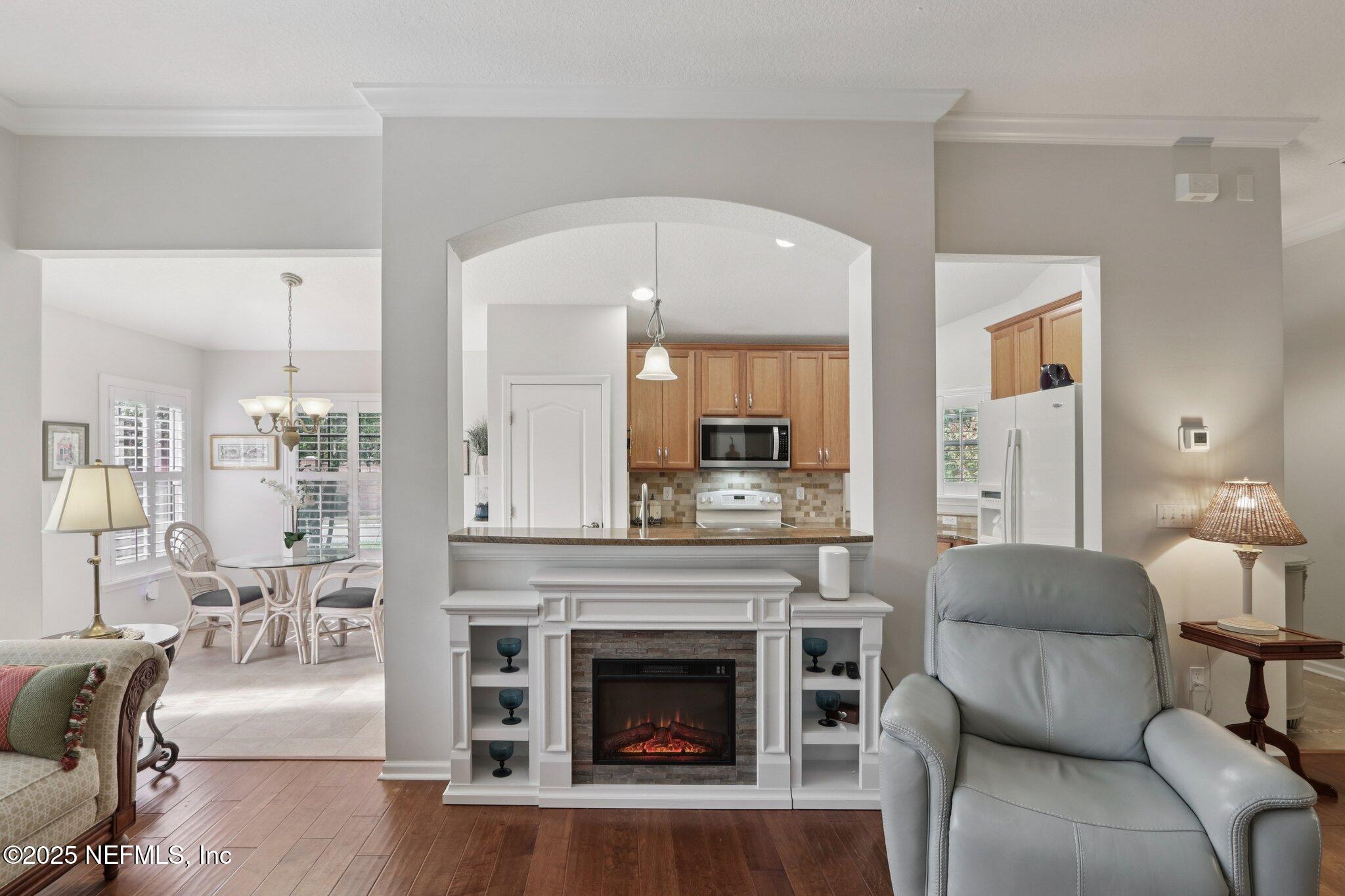 1870 Copper Stone Drive, Unit F Fleming Island, FL 32003 - Photo 9 of 36 a living room with furniture and a fireplace