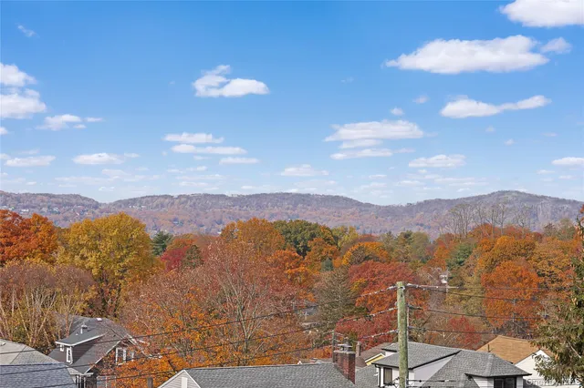 a view of backyard with barbeque grill and a small yard