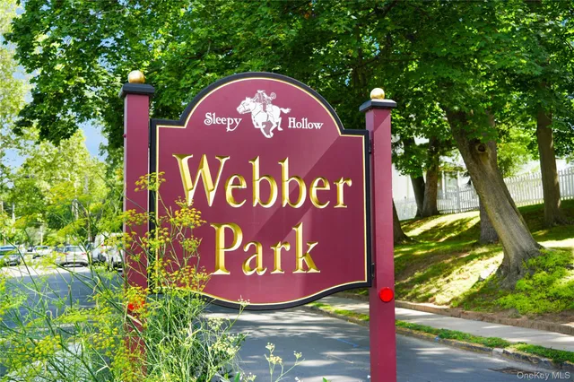 a view of swimming pool with table and chairs