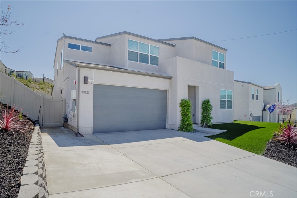 35323 Orchard Trail Fallbrook, CA 92028 - Photo 2 of 30 a view of a house with a yard and garage