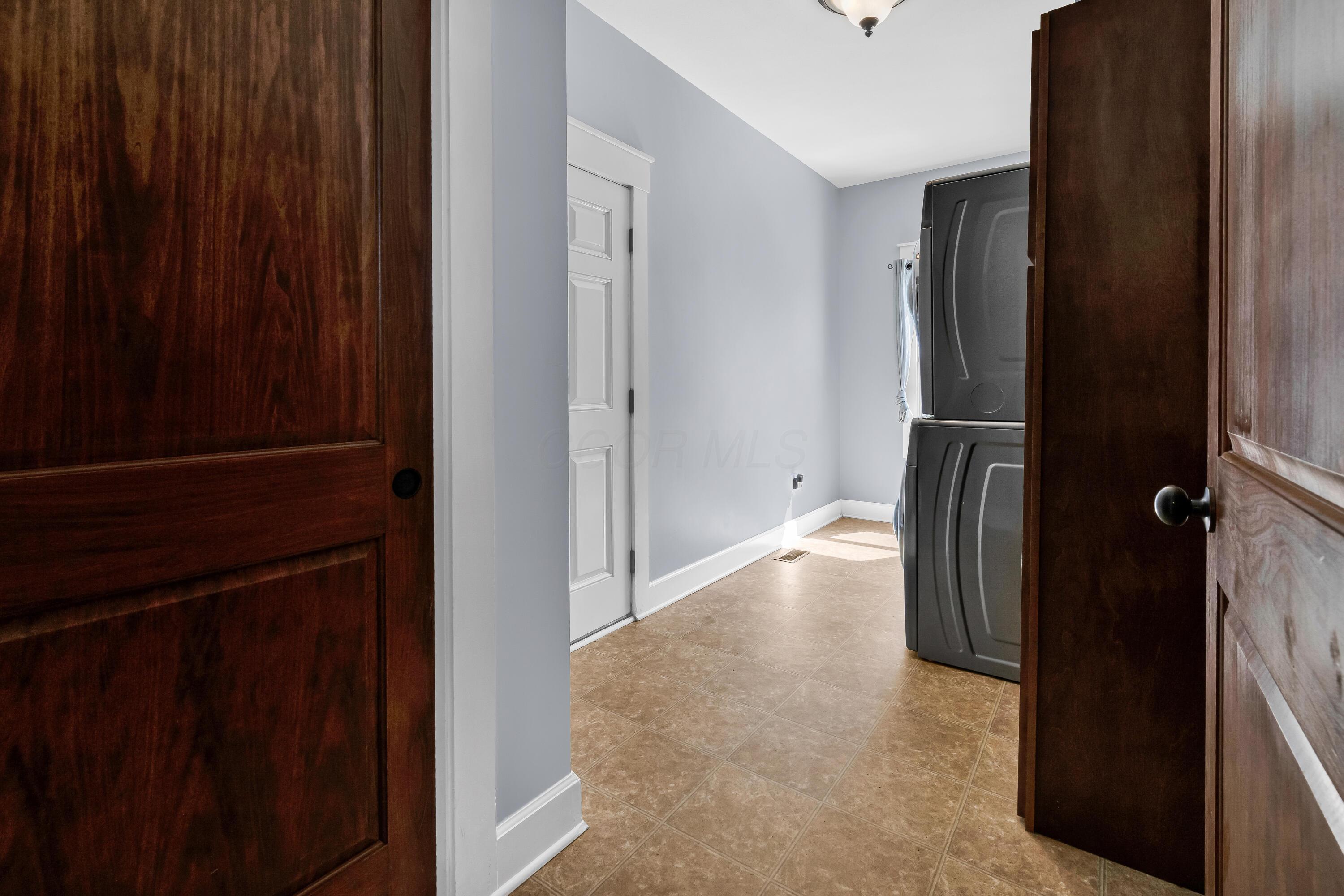 16689 Bailor Road Laurelville, OH 43135 - Photo 15 of 73 Neutral vinyl flooring
• Grey painted walls
• Wall cabinets remain
• Ceiling light
• Washer & dryer are
negotiable
• Enclosed utility sink
• Electric dryer hookup
• Drapes remain
• Closet with double
sliding door