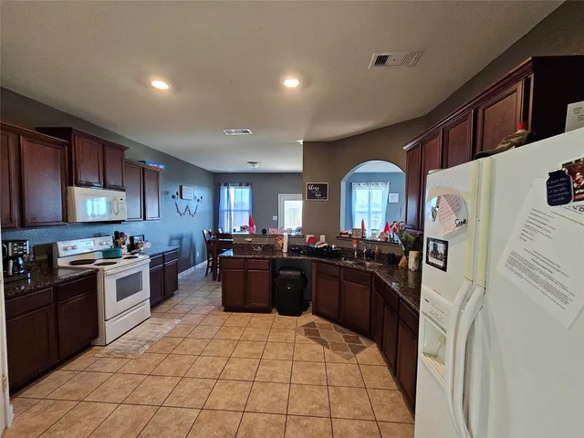 a large kitchen with stainless steel appliances granite countertop lots of counter top space