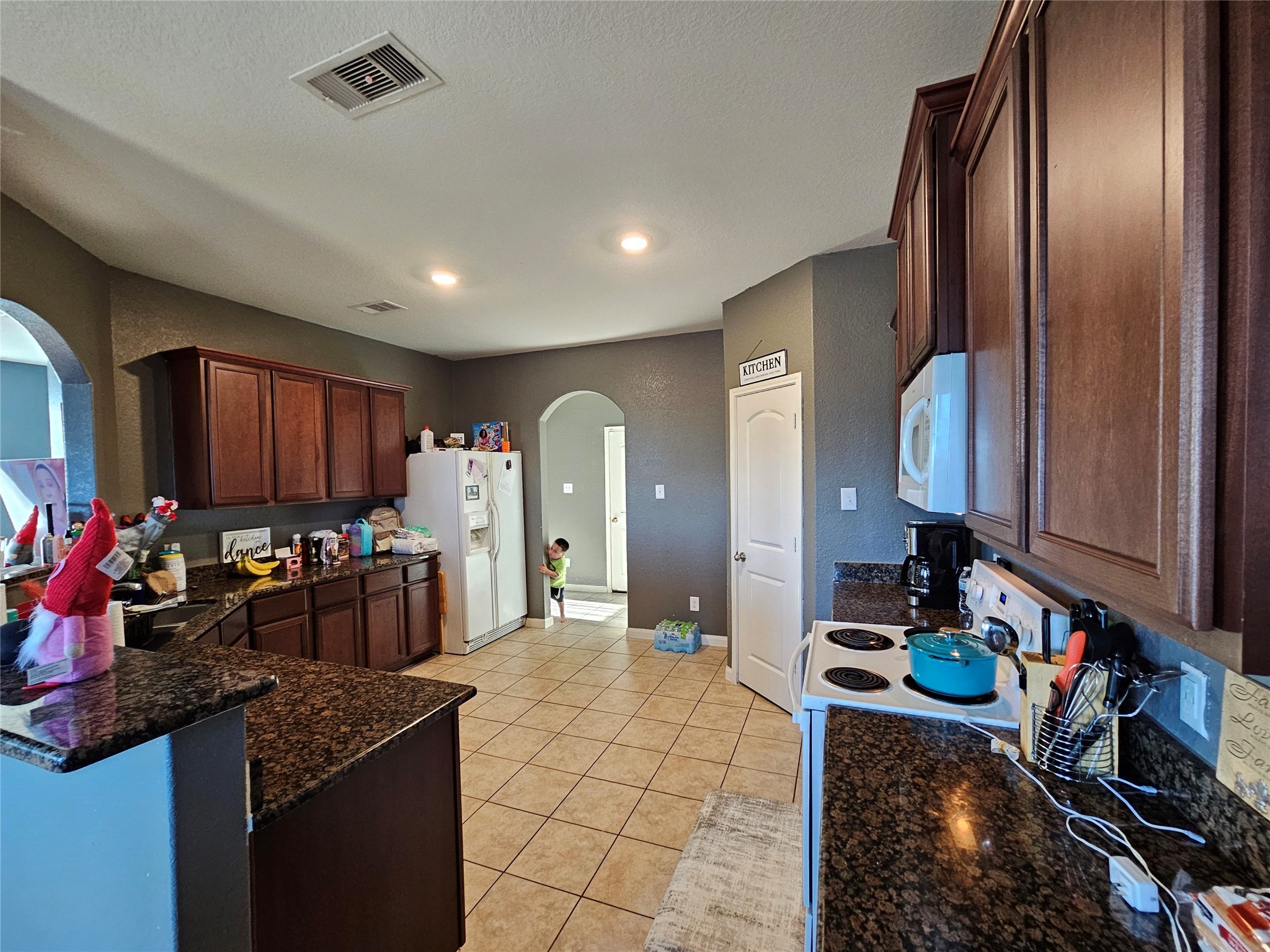 5538 Rainbow Rd. Baytown, TX 77523 - Photo 3 of 11 a kitchen with stainless steel appliances granite countertop a sink stove and cabinets
