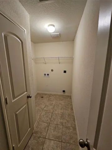a living room with furniture a flat screen tv and gym equipment