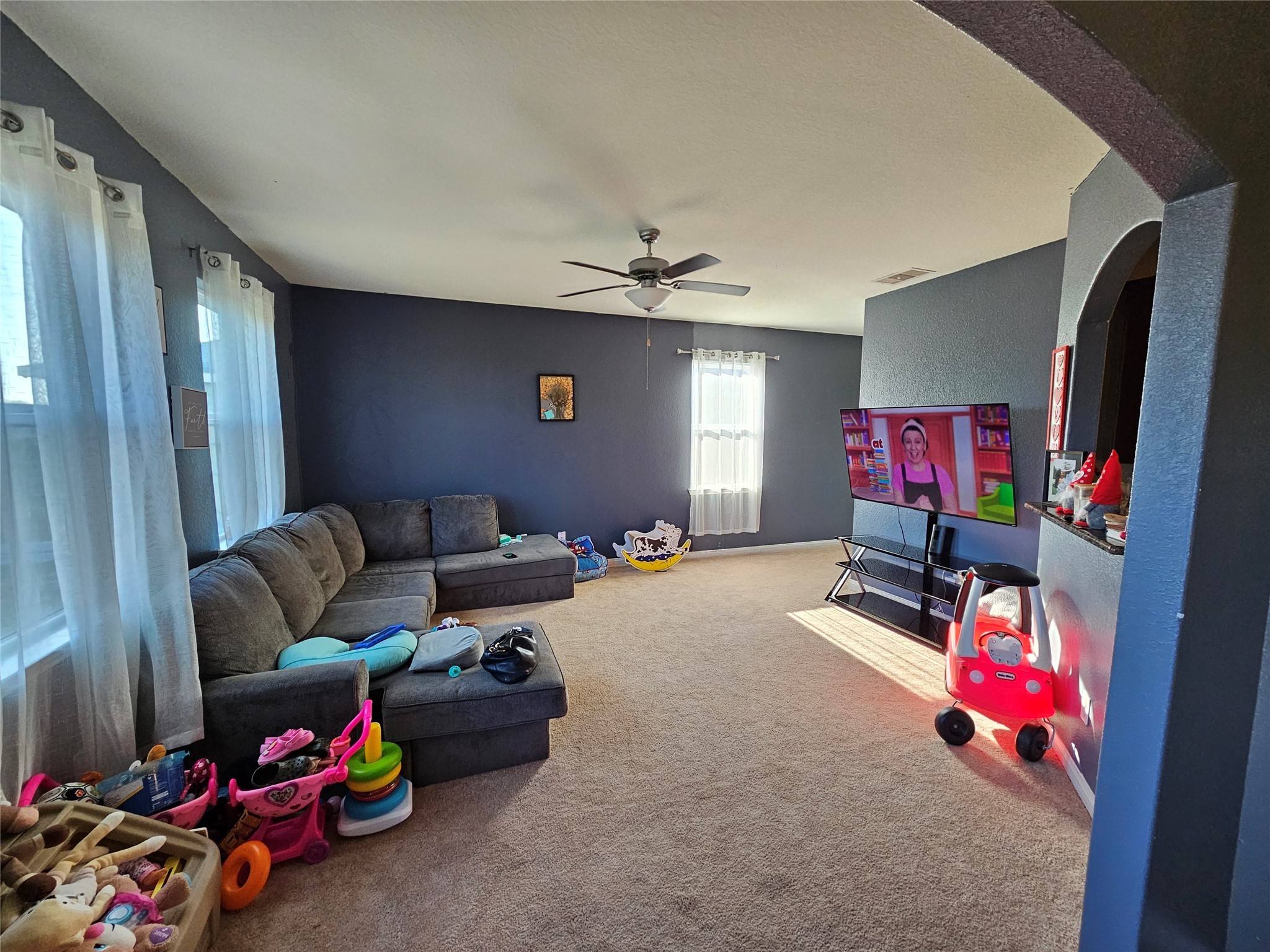 5538 Rainbow Rd. Baytown, TX 77523 - Photo 8 of 11 a living room with furniture a flat screen tv and gym equipment