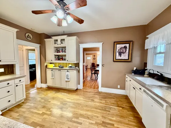 a kitchen with stainless steel appliances granite countertop a stove cabinets and wooden floor