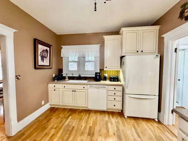 a kitchen with stainless steel appliances a refrigerator sink and cabinets