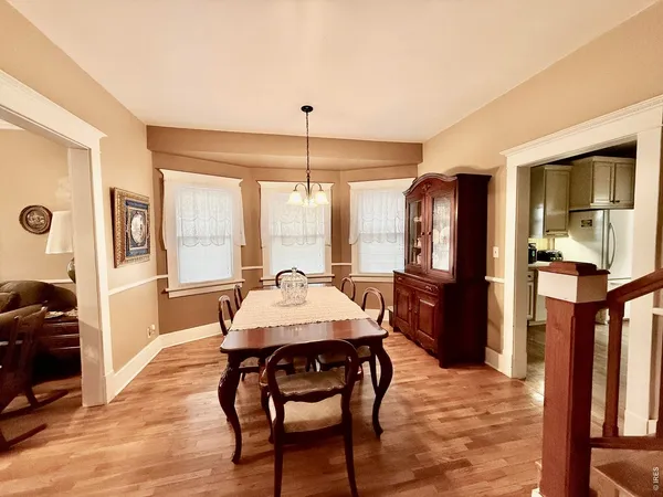 a kitchen with a table chairs refrigerator and cabinets