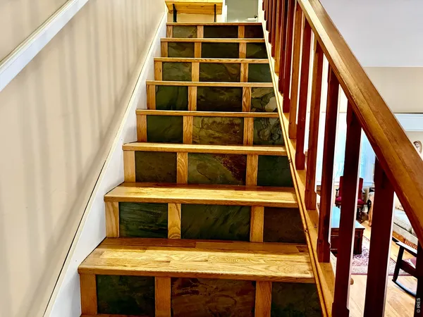 a view of staircase with white walls and a window