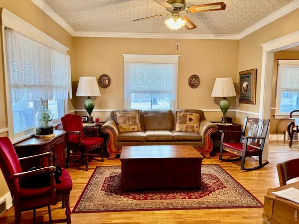a living room with furniture a table and a chandelier