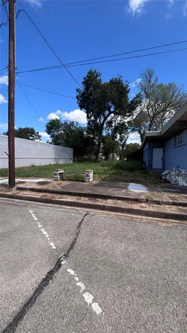 a view of a house with a yard and a car parked side of it