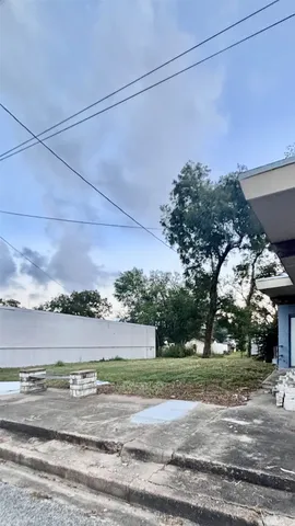 a view of a big house in a big yard with large trees