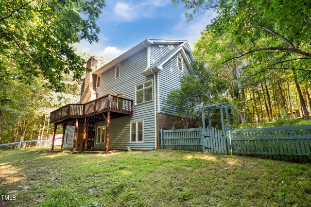 a view of a house with a yard and tree s