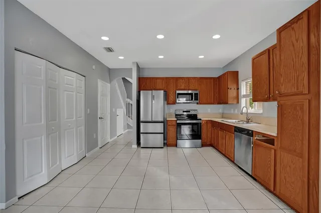 a large kitchen with stainless steel appliances lots of counter top space and cabinets