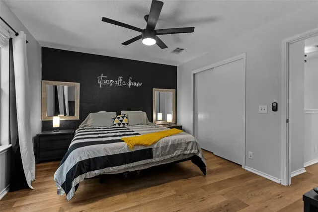 a bedroom with a bed and a ceiling fan